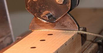 Pressing frets into place