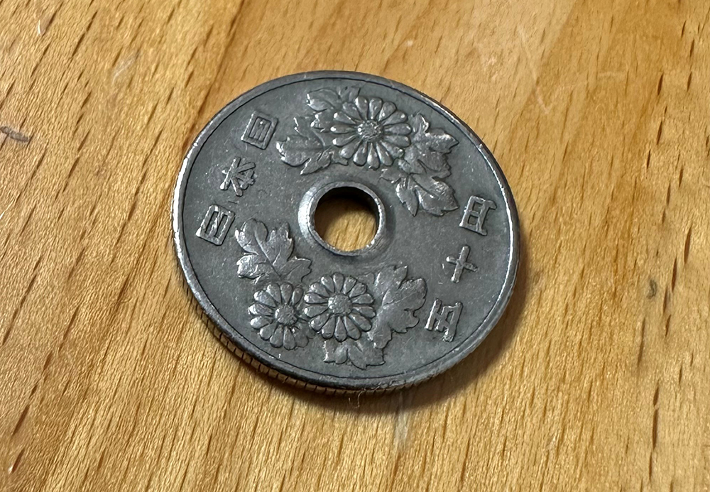 A fifty yen piece like the ones Scotti Hill uses on his guitars.