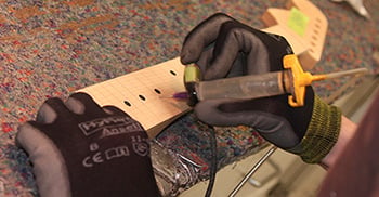 Gluing fret slots on a replacement neck.